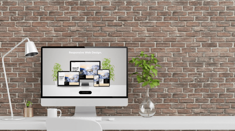 computer against brick wall with lamp