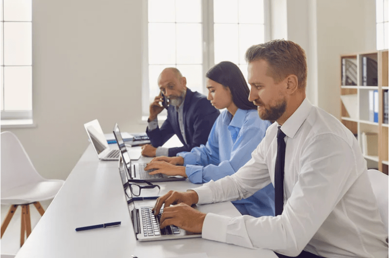 three people working on computers