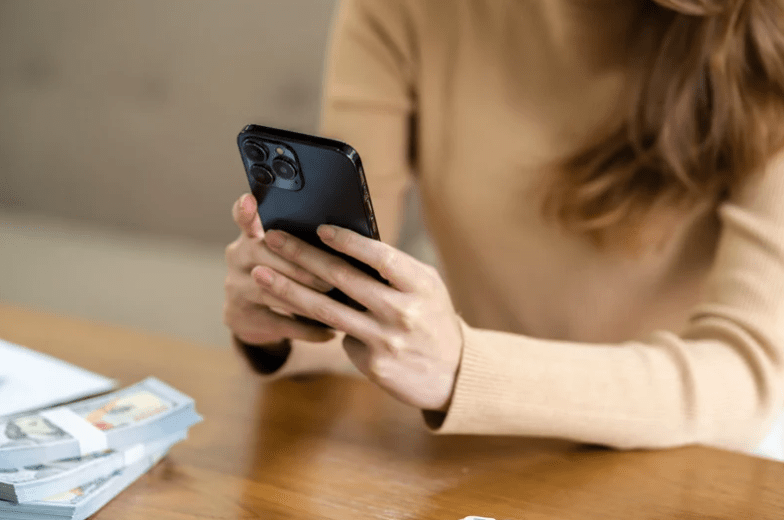 woman in brown shirt phone