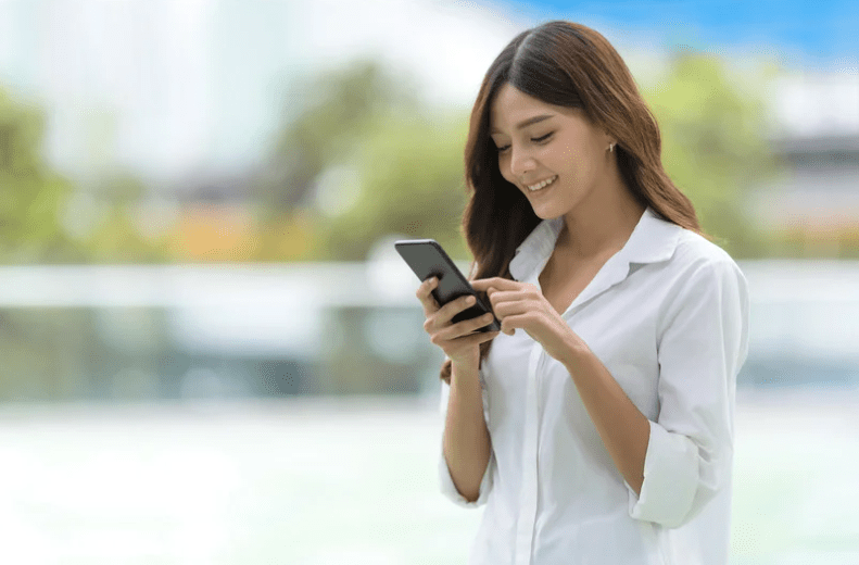 woman white shirt on phone outside