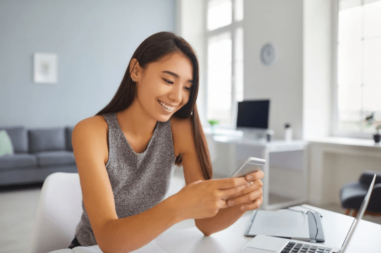 woman in gray shirt on phone