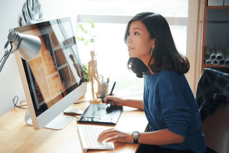 woman sitting and working on computer
