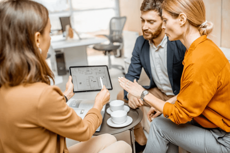 three professionals on tablet